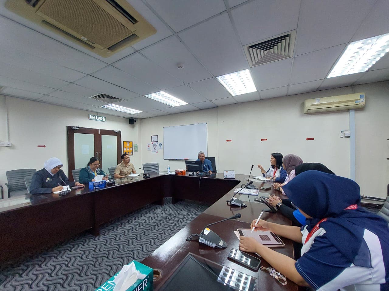 Committee members in a planning meeting around a conference table