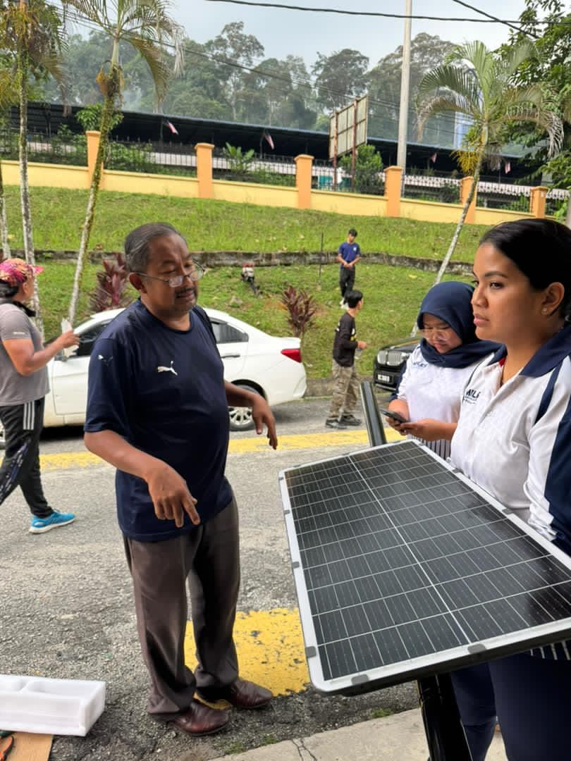 A briefing beside a solar panel before it is mounted